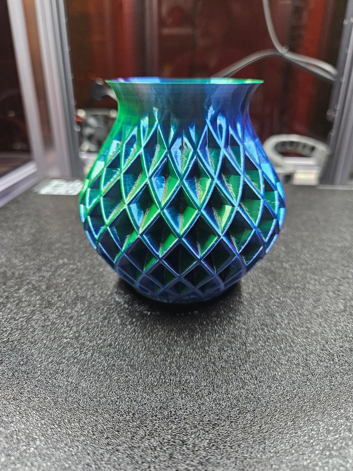 Our SUNLU tri-color Double Twisted Vase showing blue and green silk highlights on the printer bed